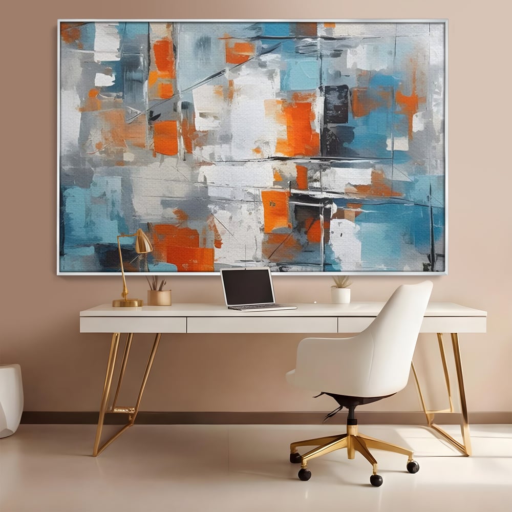 Tablou canvas cu pictura abstracta cu blocuri portocalii si albastre, in rama de aluminiu argintiu, pe perete intr-un birou